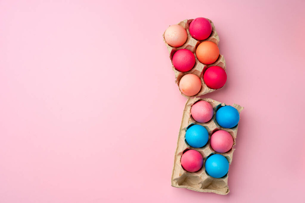 Painted Easter eggs on pink background top view - Фото, изображение
