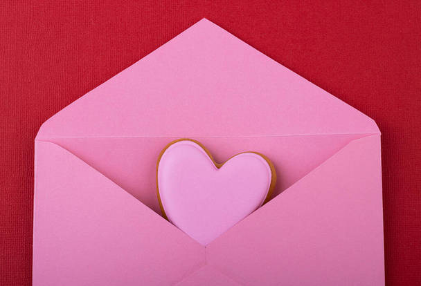 open pink envelope with pink hearts on a red background. Valentine's day, mother's day - Фото, зображення