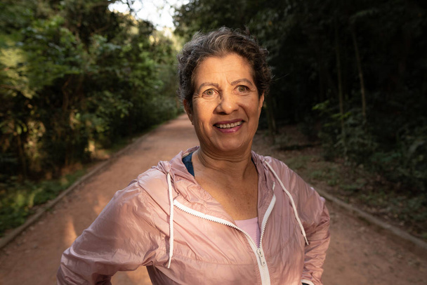 1日を開始し、運動する準備ができてスポーツウェアと成熟した黒ブラジルの女性の肖像画。晴れた日に屋外。退職、幸福、積極的、健康的な概念. - 写真・画像