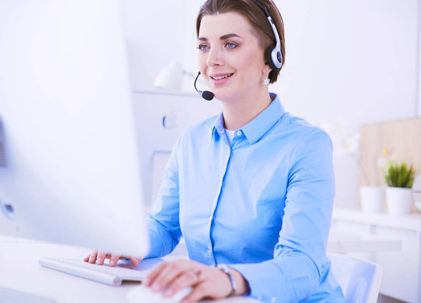 Serious pretty young woman working as support phone operator with headset in office - Fotografie, Obrázek