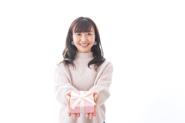 Young woman in suit holding gift box on white background, - Photo, Image