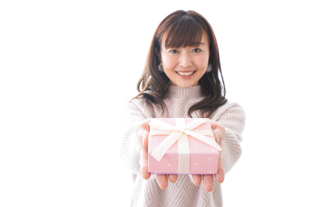 Young woman in suit holding gift box on white background, - Photo, Image