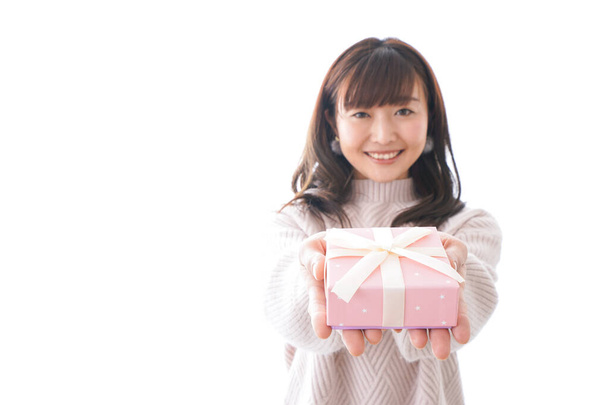 Young woman in suit holding gift box on white background, - Fotografie, Obrázek