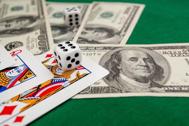 dice, playing cards on a green cloth in a casino dollars and euro bills - 写真・画像