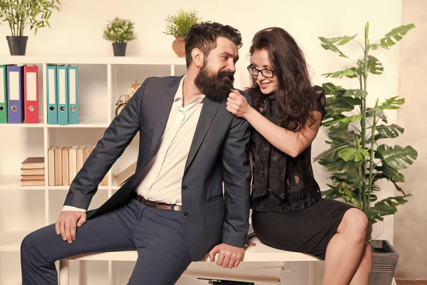 Do what you love. Couple in love sit on office desk. Couple of business partners. Professional couple. Working with spouse. Business relations. Work relationship. Career or family. Dual career couple - Photo, image