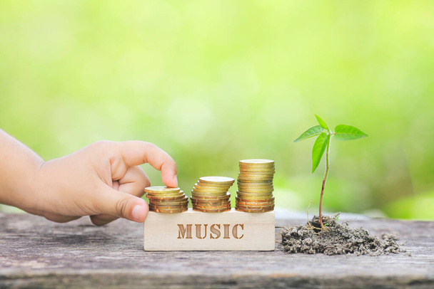 MUSIC WORD Golden coin stacked with wooden bar - Photo, Image