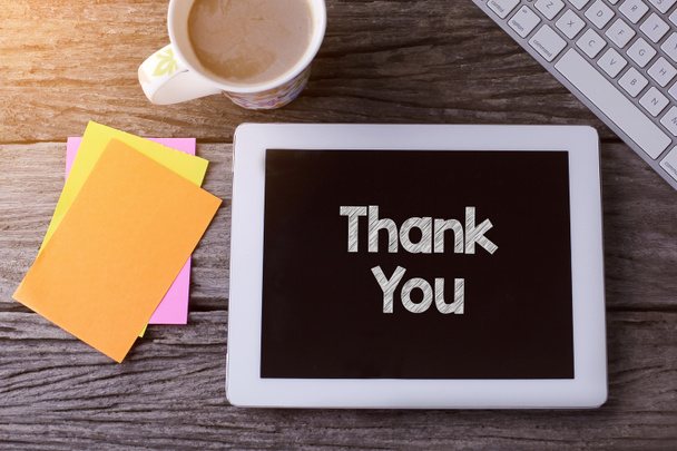 Tablet pc with Thank You and a cup of coffee on wooden background - Photo, Image