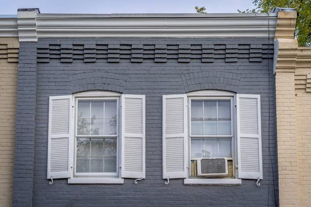 Real Estate: upscale, luxury historic  townhouse facade colonial Georgian style symmetric double pan windows dark shutters, yellow, gray, blue, - Photo, Image
