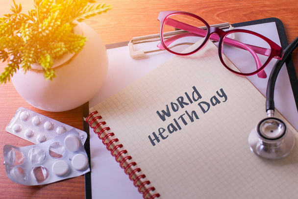 Stethoscope on note book with World Health Day words as medical concept - Photo, Image