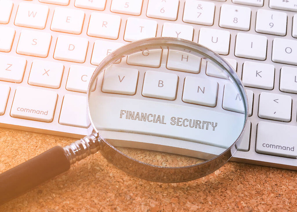 Business concept: FINANCIAL SECURITY on computer keyboard background - 写真・画像