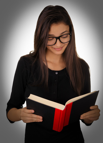 Girl With Glasses Reading a Book - 写真・画像