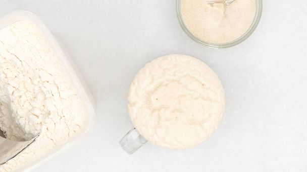 Homemade starter yeast growing. Step by step bread dough recipe, close up view from above - 写真・画像