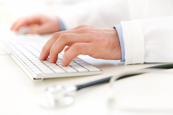 Details of doctor hands typing on keyboard - Zdjęcie, obraz