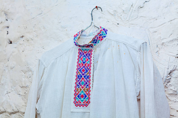 Old style shirt made of hemp fabric . Old fashioned romanian traditional clothing . White shirt from middle ages - Photo, Image