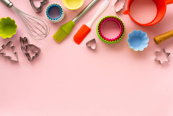 Flat lay of various baking utensils on pink background. Space for text - Foto, Bild