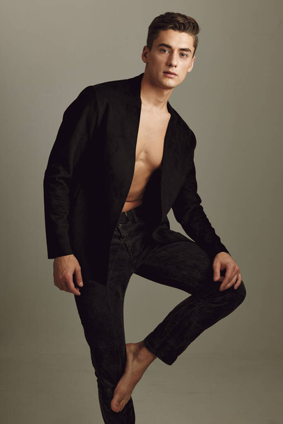 man in black unbuttoned shirt posing fashionable clothes studio self-confidence - Foto, afbeelding