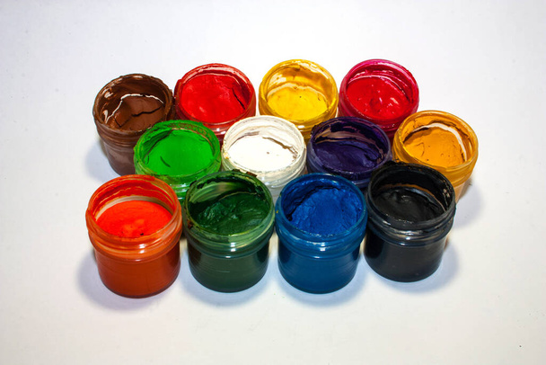 Twelve cans of paint on a white background. - Foto, Imagen