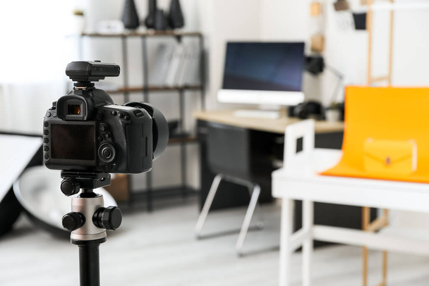 Professional camera on tripod in modern photo studio - Фото, изображение