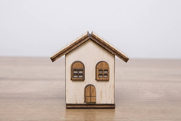 Real estate agent house model. Small house model made of wood. Real estate concept. - Foto, imagen