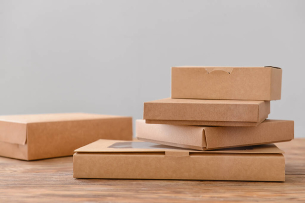 Blank cardboard boxes on wooden table - Foto, Imagem