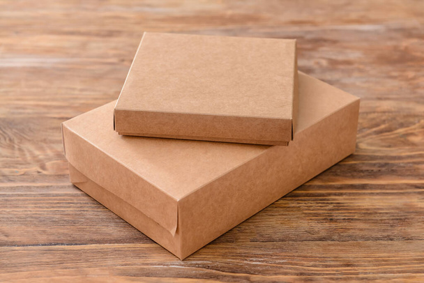 Blank cardboard boxes on wooden background - Photo, Image