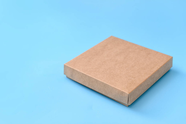 Blank cardboard box on color background - Foto, Imagem