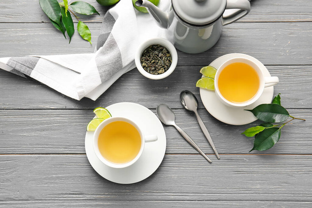 Složení s šálky zeleného čaje na dřevěném stole - Fotografie, Obrázek