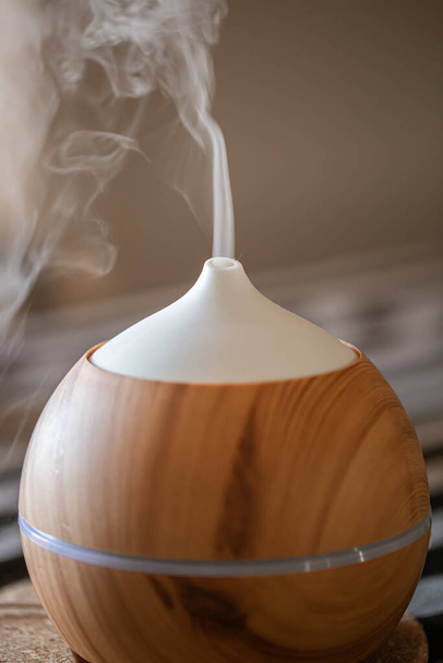 Essential oil aroma diffuser humidifier diffusing water articles in the air. - Photo, Image