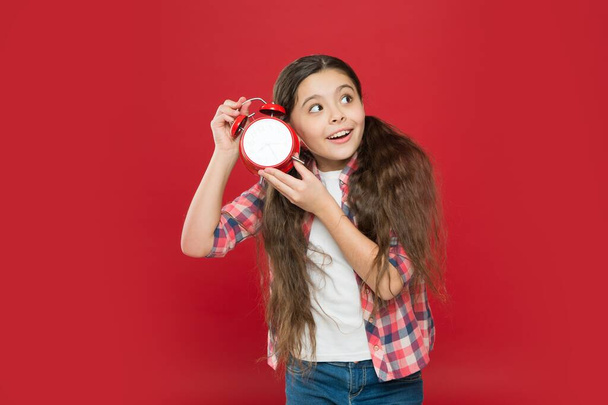 amazed teen girl with vintage clock. alarm clock. time for holiday. time for school shopping. happy childhood. countdown to christmas or new year. child listening alarm ring - Photo, Image
