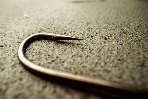 Fishing hooks on concrete textured background macro - Fotografie, Obrázek