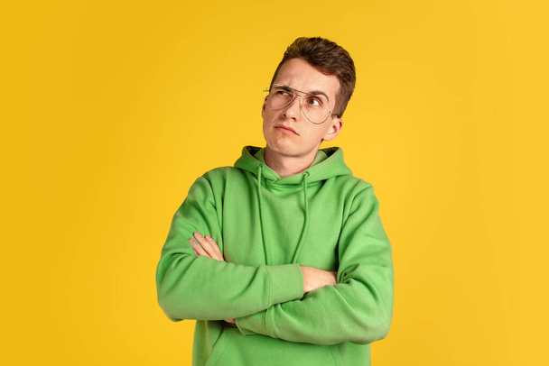 Portrait of young caucasian man isolated on yellow studio background - Fotografie, Obrázek