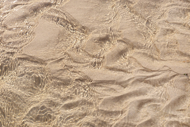Sand underwater background texture. Clear ripple sea wave and white sand. Top view - Photo, Image