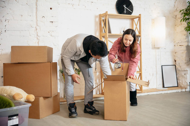 New property owners, young couple moving to new home, apartment, look happy - Fotoğraf, Görsel