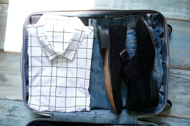 Packing suitcase at home with business man items - Photo, Image