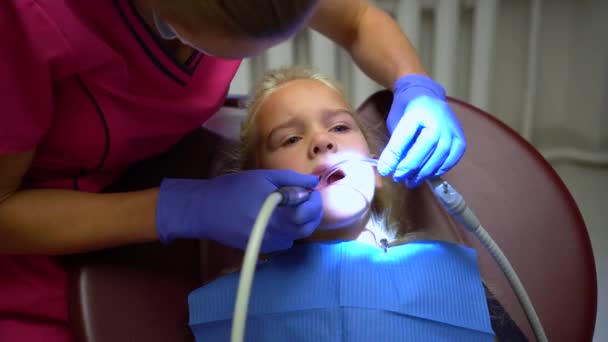 Stomatologin poliert kleinen Mädchen Zahnschmelz, Mundhöhlenschutz - Filmmaterial, Video