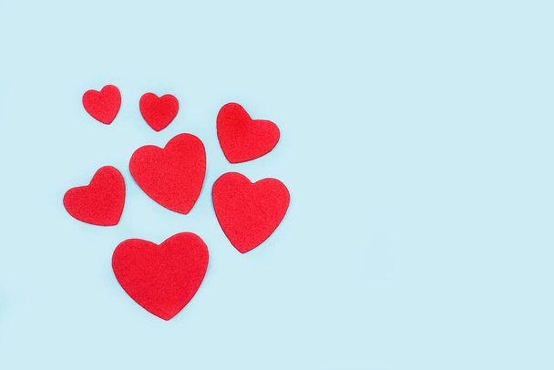 Red paper hearts on a light blue background with copy space - Photo, Image