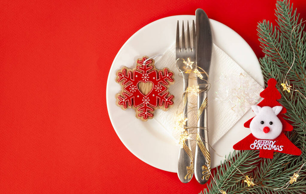 Servírované vánoční stůl poškrábaný s dekorativními symboly na červeném pozadí - Fotografie, Obrázek