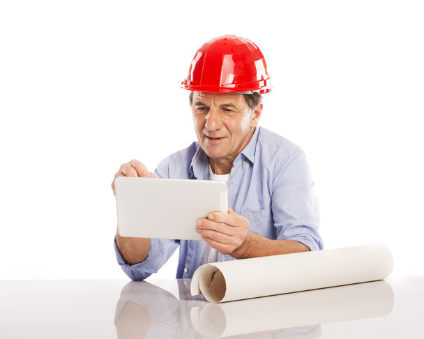 Engineer using digital tablet and plans - Фото, зображення