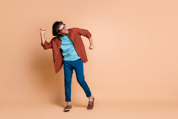 Full length photo of man dance open mouth wear specs brown t-shirt pants shoes isolated beige color background - Valokuva, kuva
