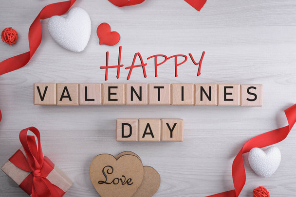 Background for Valentine's Day greeting card.Valentines day concept.Inscription happy, merry valentines day on wooden cubes. - Фото, изображение