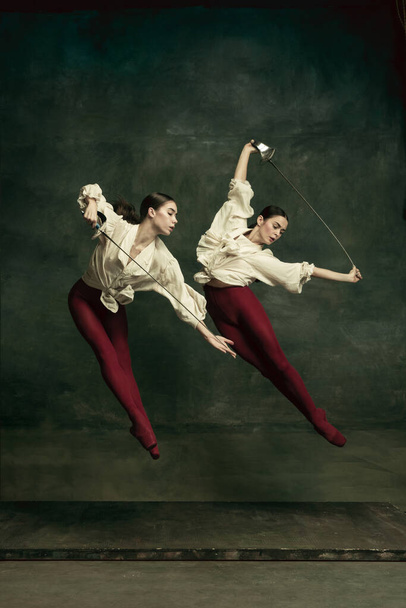 Two young female ballet dancers like duelists with swords. Ballet and contemporary choreography concept. Creative art photo. - Foto, Imagem