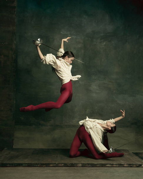 Two young female ballet dancers like duelists with swords. Ballet and contemporary choreography concept. Creative art photo. - Фото, зображення