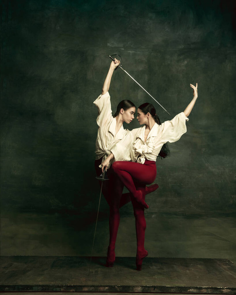 Two young female ballet dancers like duelists with swords. Ballet and contemporary choreography concept. Creative art photo. - Photo, Image