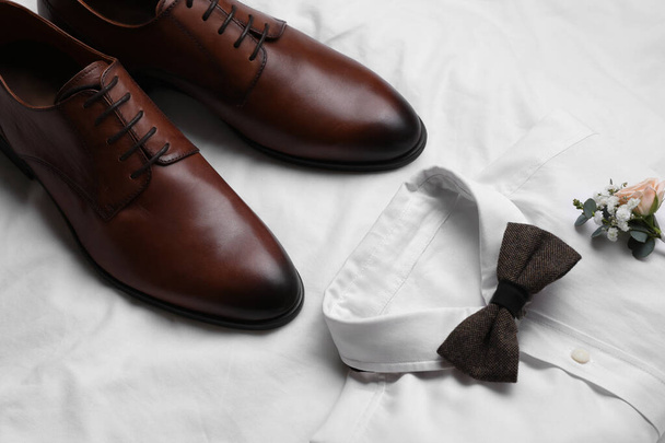 Wedding shoes and shirt on white fabric - Photo, Image