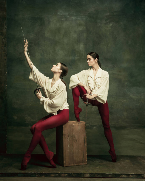 Two young female ballet dancers like duelists with swords. Ballet and contemporary choreography concept. Creative art photo. - Φωτογραφία, εικόνα