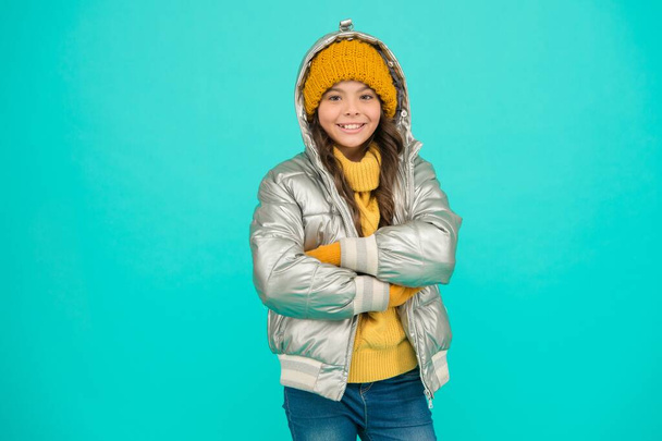 happy kid in silver puffer jacket and knitwear get warm in winter ready for activity on holidays, xmas vacation - Foto, immagini