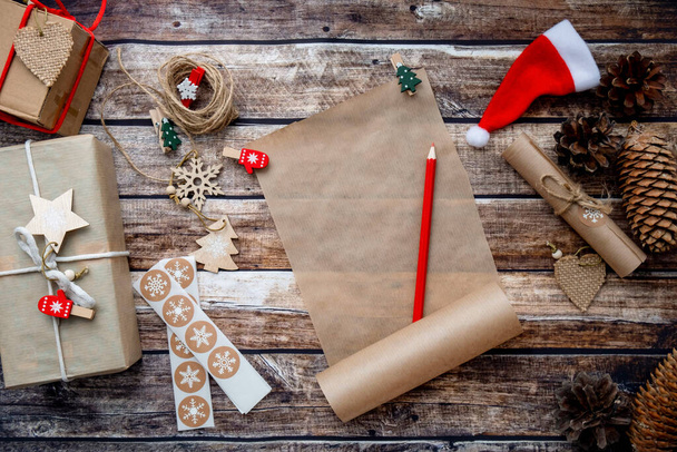 letter to santa claus, christmas wishlist on wooden background among holida - Фото, изображение