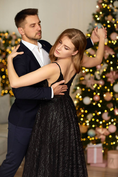Beautiful couple dancing in the living room - Fotó, kép