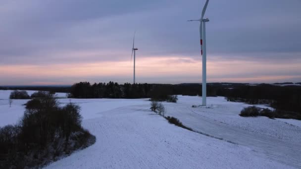 Вид с воздуха на ветряную электростанцию зимой. Вид с воздуха на вращающиеся ветряные турбины на снежном поле в Германии. - Кадры, видео