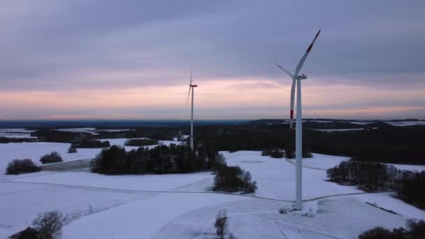 Vista aérea de un parque eólico en invierno. Vista aérea de aerogeneradores giratorios en un campo cubierto de nieve en Alemania. - Metraje, vídeo